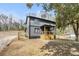 Side view of a gray two-story home with a wooden porch, showing the house and surrounding yard at 441 Pomona Sw Cir, Atlanta, GA 30315