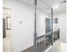 Bright hallway with modern railings leads to other rooms, creating a smooth transition between living spaces at 441 Pomona Sw Cir, Atlanta, GA 30315