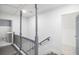 Bright hallway with modern railings leads to updated bathroom, providing a transition to personal spaces at 441 Pomona Sw Cir, Atlanta, GA 30315