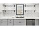Modern kitchen features white marble counters, subway tile backsplash and open shelving at 441 Pomona Sw Cir, Atlanta, GA 30315