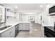 Bright kitchen boasts gray cabinets, stainless steel appliances, and decorative open shelving at 441 Pomona Sw Cir, Atlanta, GA 30315