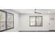Living room featuring gray floors, white walls, ample natural light, and a ceiling fan at 441 Pomona Sw Cir, Atlanta, GA 30315