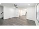 Spacious living room featuring gray floors with opening to kitchen and entrance to stairway at 441 Pomona Sw Cir, Atlanta, GA 30315