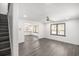 Open-concept living room with gray floors, ceiling fan, and view of kitchen through an opening at 441 Pomona Sw Cir, Atlanta, GA 30315