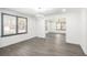 Open living room and dining area with gray wood floors and neutral wall colors and ample light at 441 Pomona Sw Cir, Atlanta, GA 30315