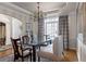 Stylish dining area featuring a glass-top table, upholstered chairs, and elegant window treatments at 1615 Chattahoochee Run Dr, Suwanee, GA 30024