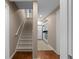 Hallway with stairs leading up to a kitchenette featuring a refrigerator, sink and microwave at 1615 Chattahoochee Run, Suwanee, GA 30024