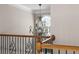 Chandelier and arched window view from hallway and decorative wrought iron railing at 1615 Chattahoochee Run Dr, Suwanee, GA 30024