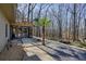 Gravel walkway leads to a screened porch surrounded by wooded privacy at 241 Lancaster Cir, Marietta, GA 30066