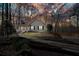 Exterior view of the home at sunset with mature trees and manicured landscaping at 241 Lancaster Cir, Marietta, GA 30066