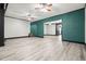 Spacious living room with light wood floors, painted accent wall, and modern ceiling fans at 241 Lancaster Cir, Marietta, GA 30066