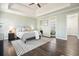 Relaxing main bedroom with hardwood floors, neutral paint, tray ceiling, and ensuite bathroom at 241 Lancaster Cir, Marietta, GA 30066