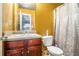 Bathroom vanity featuring granite countertops, wooden cabinetry, and a decorative mirror at 4230 Spur Look Xing, Douglasville, GA 30135