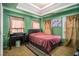 Bedroom showcasing a tray ceiling, two windows, and neutral carpet at 4230 Spur Look Xing, Douglasville, GA 30135