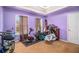 Bedroom featuring a tray ceiling, two windows with curtain coverings, and carpeted floors at 4230 Spur Look Xing, Douglasville, GA 30135