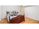Bedroom featuring hardwood floors, a door, and neutral walls with lots of extra items on the bed at 4230 Spur Look Xing, Douglasville, GA 30135