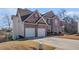 Well-maintained brick home with a two-car garage and a large driveway at 4230 Spur Look Xing, Douglasville, GA 30135