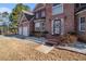 Close-up view of brick house entrance and garage; step up to covered front porch at 4230 Spur Look Xing, Douglasville, GA 30135