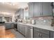 Modern kitchen with stainless steel appliances and gray cabinets, backsplash, and window at 4230 Spur Look Xing, Douglasville, GA 30135