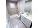 Updated bathroom with beige tile shower, white vanity, and ceramic tile flooring at 1152 Greenwich Sw St, Atlanta, GA 30310