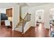 Bright foyer area with hardwood floors, staircase, and an archway leading to other living spaces at 1840 Beyers Landing Dr, Buford, GA 30519