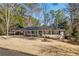 Charming single-story home featuring a cozy covered porch and a well-maintained lawn, surrounded by lush trees at 2723 Esquire Way, Tucker, GA 30084