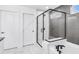 Modern bathroom featuring a glass-enclosed shower, soaking tub with black matte hardware, and neutral tile at 5410 Julep Ct, Cumming, GA 30028