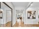 Bright foyer featuring hardwood floors, large mirror, neutral color palette and an open view of the home's living spaces at 5410 Julep Ct, Cumming, GA 30028