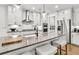 Modern kitchen with stainless steel appliances, white cabinets, and a large island with seating at 5410 Julep Ct, Cumming, GA 30028