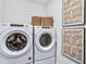 Clean laundry room with a washer and dryer set and decorative wall art at 5410 Julep Ct, Cumming, GA 30028