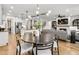 Open-concept area with a dining area, kitchen, and living room, creating a spacious and inviting atmosphere at 5410 Julep Ct, Cumming, GA 30028