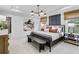 Spacious main bedroom featuring tray ceilings, a plush bed, and views to the outside at 5410 Julep Ct, Cumming, GA 30028