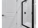 Shower with white marble-look tile and a glass door next to a white door at 5410 Julep Ct, Cumming, GA 30028