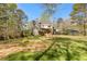 View of the back of the home, highlighting the deck area and lush backyard, perfect for relaxation and outdoor activities at 8078 Longleaf Dr, Villa Rica, GA 30180