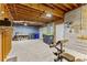 Unfinished basement space with exposed ceiling, concrete floor, shelving, and a door at 8078 Longleaf Dr, Villa Rica, GA 30180