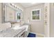 Bathroom with granite countertops, white cabinets, large vanity mirror and great light at 8078 Longleaf Dr, Villa Rica, GA 30180