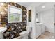 Charming half bathroom and laundry area with wallpaper, toilet, washer, and dryer at 8078 Longleaf Dr, Villa Rica, GA 30180