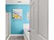 Bathroom is bright and airy, with blue accent wall and a tub/shower at 8078 Longleaf Dr, Villa Rica, GA 30180