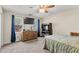 Bedroom features neutral colors, large windows, a ceiling fan, and carpet flooring at 8078 Longleaf Dr, Villa Rica, GA 30180