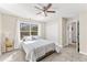 Cozy bedroom featuring a ceiling fan, closet, and window overlooking the exterior at 8078 Longleaf Dr, Villa Rica, GA 30180