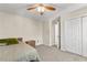 Bedroom with ceiling fan, bedside table, closet and next to the bathroom at 8078 Longleaf Dr, Villa Rica, GA 30180