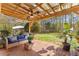 Inviting covered patio with outdoor seating, fan, string lights, and view of the backyard at 8078 Longleaf Dr, Villa Rica, GA 30180
