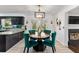 Elegant dining area with stylish chairs, modern lighting, and views to the backyard at 8078 Longleaf Dr, Villa Rica, GA 30180
