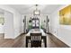 Formal dining room featuring modern lighting, wainscoting, and access to outdoor views at 8078 Longleaf Dr, Villa Rica, GA 30180