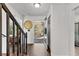 Bright entryway with wood-look flooring and a view of the front door and staircase at 8078 Longleaf Dr, Villa Rica, GA 30180
