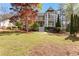 Charming two-story home with a lush front yard and beautiful landscaping, including an eye-catching red maple at 8078 Longleaf Dr, Villa Rica, GA 30180