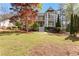 Charming home featuring a large front yard, mature trees, and welcoming front porch at 8078 Longleaf Dr, Villa Rica, GA 30180