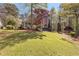Charming home featuring a large front yard, mature trees, and welcoming front porch at 8078 Longleaf Dr, Villa Rica, GA 30180