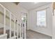 Hallway features neutral color and carpet, with a window and white banister at 8078 Longleaf Dr, Villa Rica, GA 30180