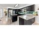 Well-equipped kitchen featuring dark cabinetry, an island with granite countertops, and stainless steel appliances at 8078 Longleaf Dr, Villa Rica, GA 30180